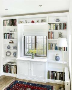 Bespoke fitted bookcases surrounding a break front cabinet