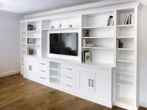 Built in cabinets around TV with shelving