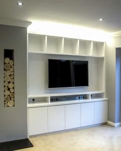 Contemporary built in media cabinets in an alcove