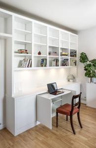 Contemporary modern fitted shelving with occasional pull out desk home office