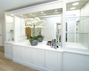 Large built in living room cupboards with mirrored backing and breakfront cupboards