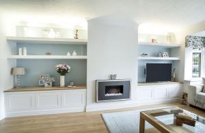 white painted lounge furniture with floating shelves