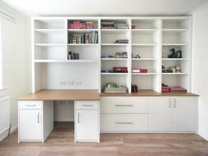 fitted home office with cabinets and shelves