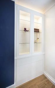 Built in cupboards in lounge with glazed doors