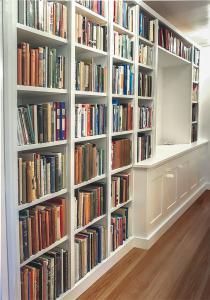 Fitted home library & cabinets in narrow hallway