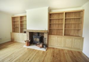 fitted cupboards around fireplace in Oak