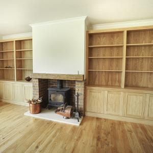 fitted cupboards around fireplace in Oak