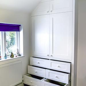 Built in shaker wardrobe with drawers in an alcove