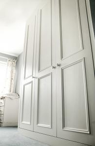 Built in wardrobe with large period panel bead