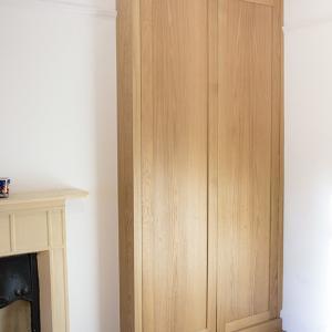 Buitl in alcove wardrobe in Oak