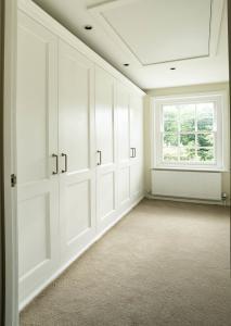 Fitted shaker wardrobes in a bedroom