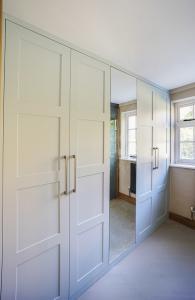 Modern fitted shaker wardrobe with mirror door
