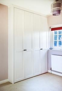 double fitted wardrobe in alcove with period moulding