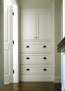 alcove unit with traditional styled framed cabinet fitted up to ceiling. Moulded doors with a simple panel bead, Painted in White eggshell