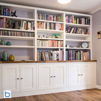 Bespoke fitted cabinets with solid oak worktop combining painted carcass with natural timber detail