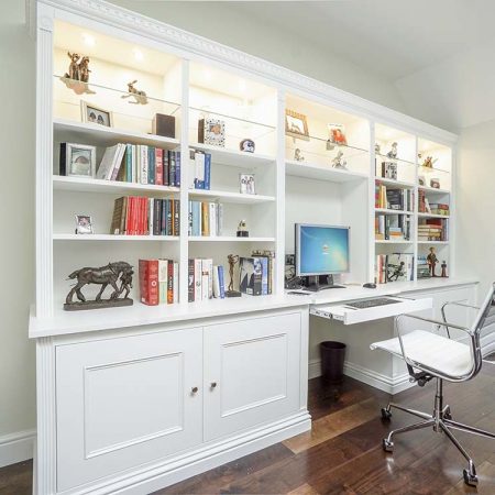 Traditional style fitted living room cabinets with integrated desk area glazed display shelves and LED lighting