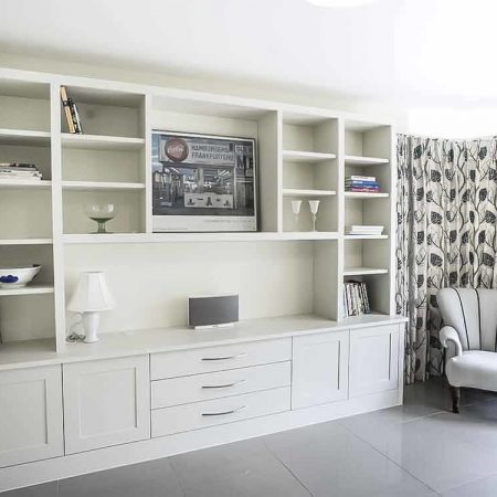 Large fitted unit with shaker doors central open display area and deep drawers Oxfordshire living room