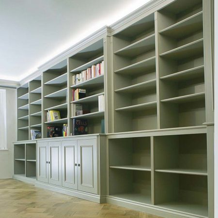 Wall to wall fitted bookcases and cupboards painted in Farrow and Ball Mouses Back traditional period style