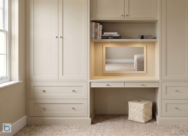Bespoke Shaker wardrobes with double Base Drawer - painted in Farrow & Ball Drop Cloth, featuring an integrated dressing table recess with a mirror, vanity drawers, and top cupboards.