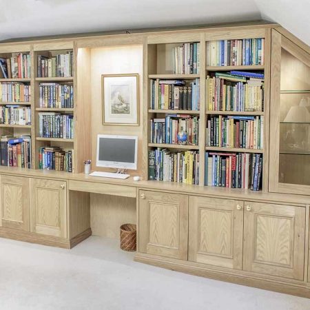 Custom made fitted cupboards and shelving in solid oak natural grain finish bespoke to room dimensions
