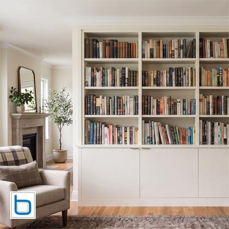 Bespoke classic outer frame bookcase featuring custom frameless base doors painted in Farrow and Ball Pointing.