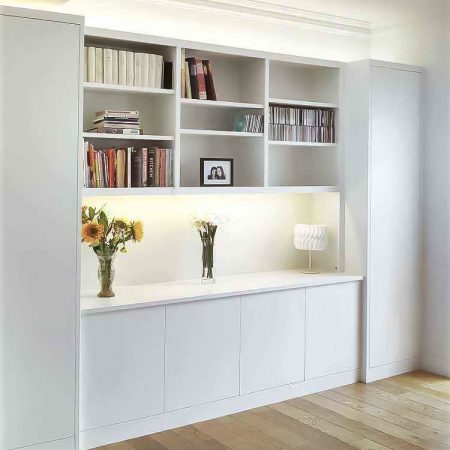 Fitted lounge furniture with integrated LED lighting and floor to ceiling bookcases