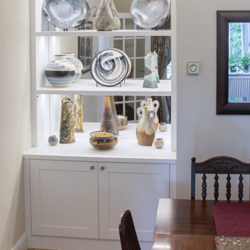 Alcove cupboards with mirror display shelves