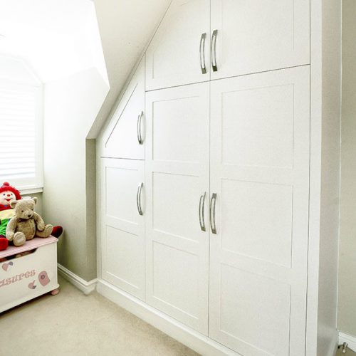 Large Shaker wardrobe under eves in this room makes the best use of this space.