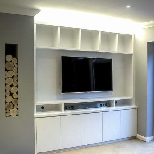 Contemporary built in media cabinets in an alcove