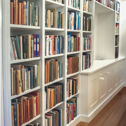 Fitted home library & cabinets in narrow hallway