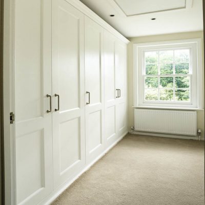 Fitted shaker wardrobes in a bedroom