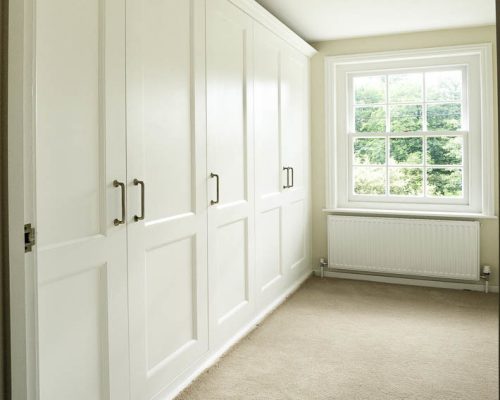 Fitted shaker wardrobes in a bedroom