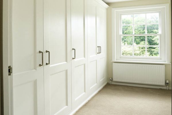 Fitted shaker wardrobes in a bedroom