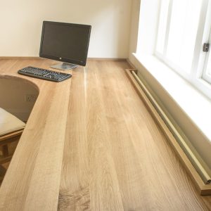 Solid oak fitted home office desk with deep overhang full-length oak Boards, over 4m long allowing natural light from side window