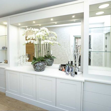Large built in living room cupboards with mirrored backing and breakfront cupboards