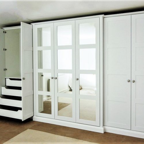 Break front four panel mirrored shaker doors in this wardrobe provide an interesting central feature on this long run of wardrobes. With internal storage with drawers hanging and shelves. Theres plenty of wardrobe space to buy yourself some more clothes!