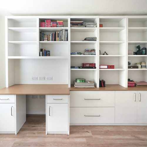 fitted home office with cabinets and shelves