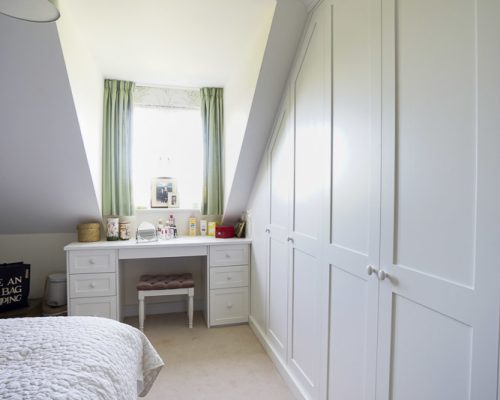 Modern fitted Shaker wardrobe in bedroom